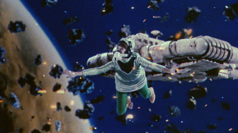 An astronaut in front of a spaceship, many meteors in Message from Space