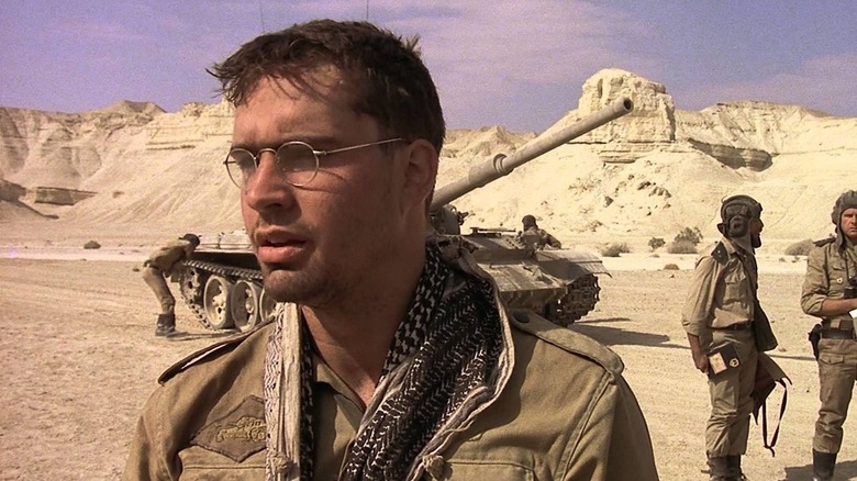 Jason Patric as Konstantin Koverchenko stands in front of a tank in The Beast