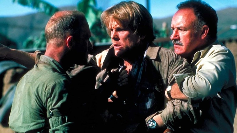 Gene Hackman as Alex Grazier holds Nick Nolte as Russell Price back from a confrontation with Ed Harris as Oates in Under Fire