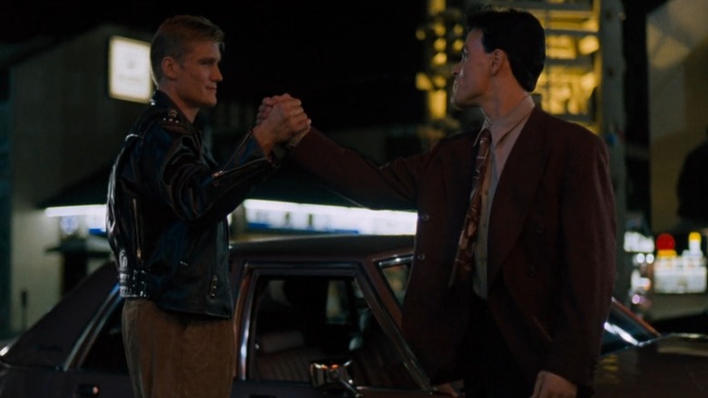 Chris Kenner (Dolph Lundgren) and Johnny Murata (Brandon Lee) clasping hands in "Showdown In Little Tokyo"