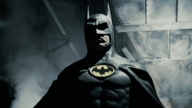 Batman emerges from a cloud of smoke in Batman