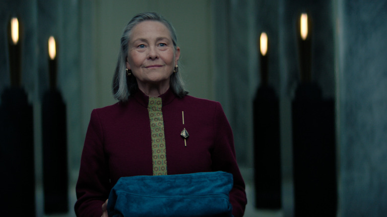 Ambassador Quent carrying a book on her way to the imperial library in Foundation