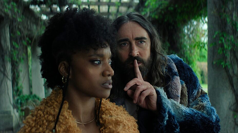 Song (Yootha Wong-Loi-Sing) looks at Brother Day (Lee Pace) holding up his finger in Foundation