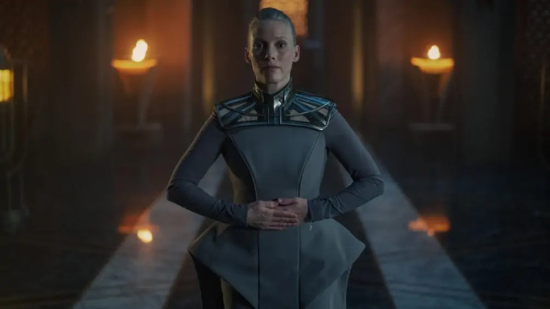 Lady Demerzel (Laura Birn) standing in torch light in Foundation