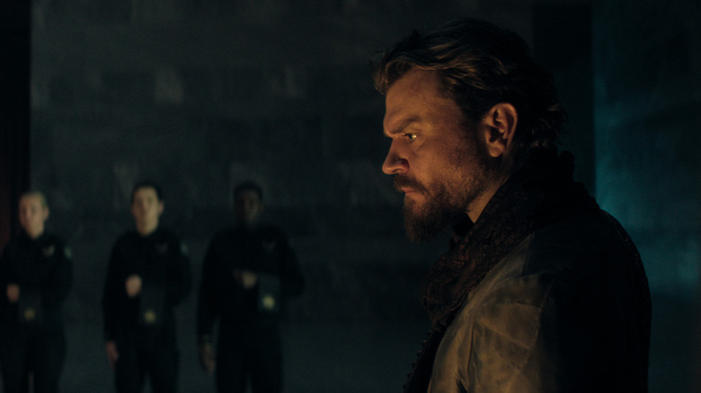 The Mule (Pilou Asbæk) shown from the side in a dim-lit room