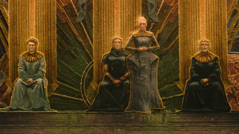 A mural depicting Demirzel stands next to the three clion in the institution