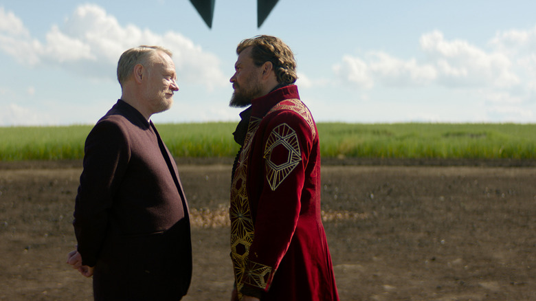 Jared Harris as Hari Seldon and Pilou Asbæk as the Mule staring each other down in a field in Foundation season 3