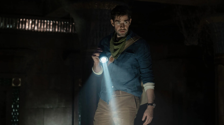 Luke, holding a flashlight in a dark tomb in Fountain of Youth.