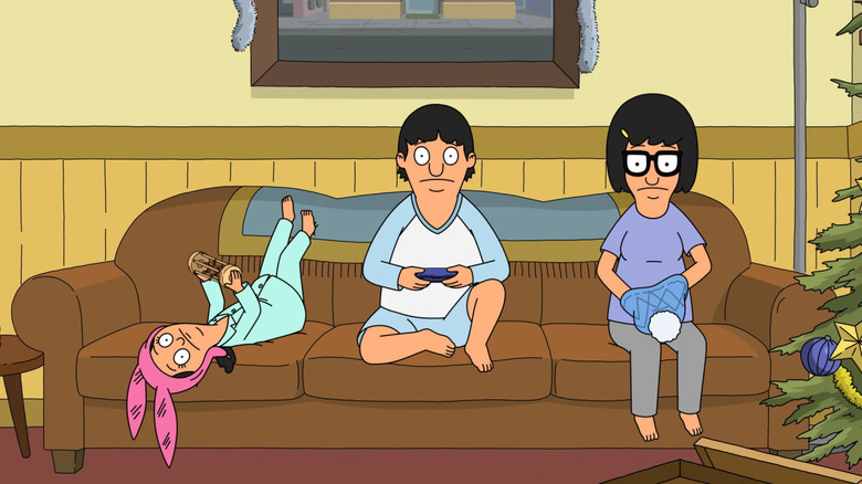 Louise, Gene, and Tina sitting on the couch in Bob's Burgers