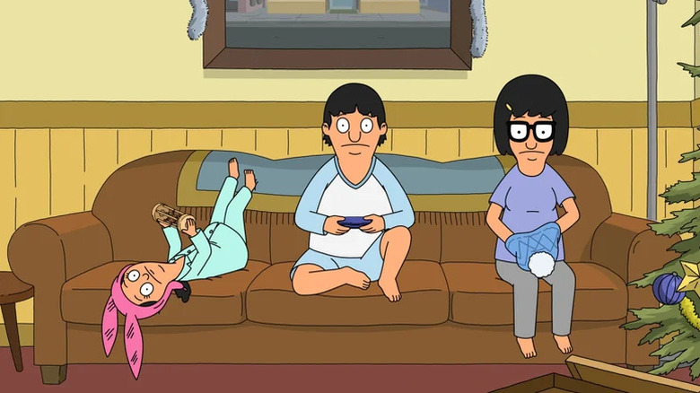 Louise, Gene, and Tina sitting on the couch in Bob's Burgers