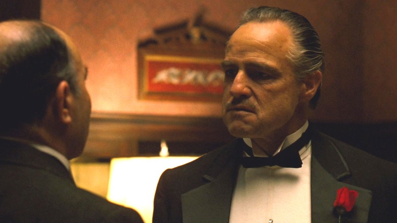 Vito Corleone standing face to face with someone in The Godfather
