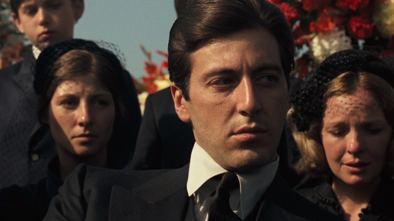 Michael looking suspiciously around at a funeral in The Godfather