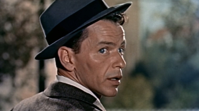 Frank Sinatra's Barney Sloan looks over his shoulder as he stands on a porch in Young at Heart