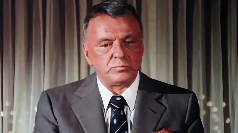 Frank Sinatra appears as himself standing in his office in a suit in Cannonball Run II