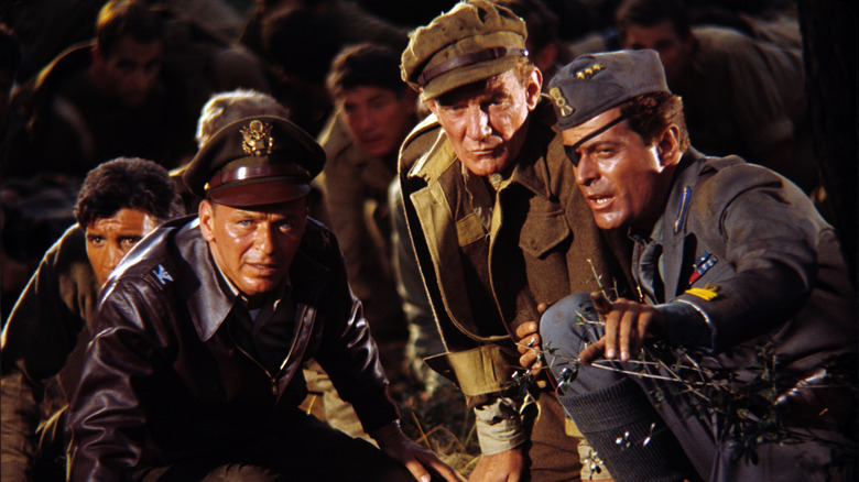 Col. Joseph L. Ryan crouching with a group of fellow soldiers in Von Ryan's Express