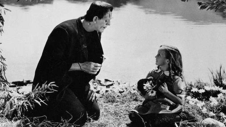 Frankenstein (1931) - Frankenstein's Monster and little girl playing with flowers in front of lake