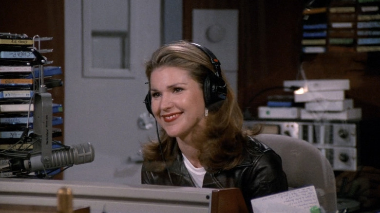 Roz smiles from her seat in the radio booth in Frasier