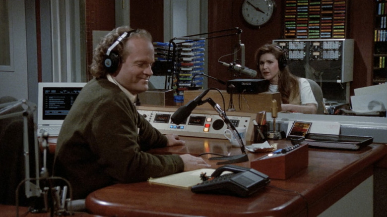 Kelsey Grammer's Frasier Crane and Perry Gilpin's Rose Doyle sit in their chairs in Frasier's radio studio