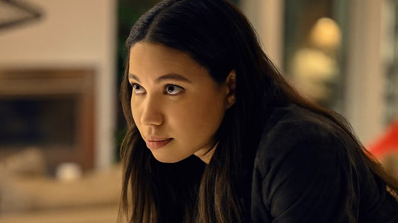 Jurnee Smollett as Michelle Calderone, leaning over her desk on Smoke