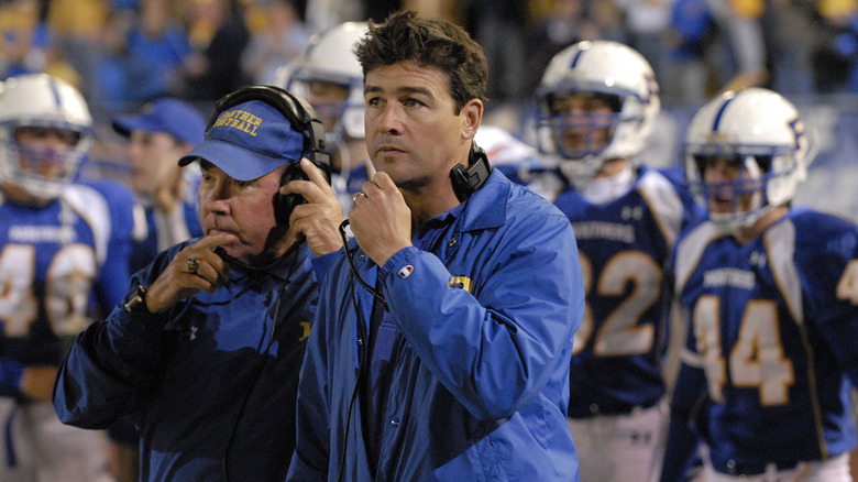 Coach Taylor (Kyle Chandler) nervously watching from the sidelines on Friday Night Lights