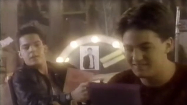 Matthew Perry's Charles Russell sits in a dressing room smiling in Boys Will Be Boys