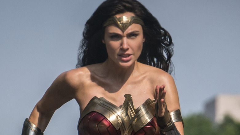 Gal Gadot as Wonder Woman running down the street in Wonder Woman 1984