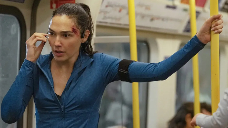 Maia on the phone on the subway with a cut on her forehead in The Runner