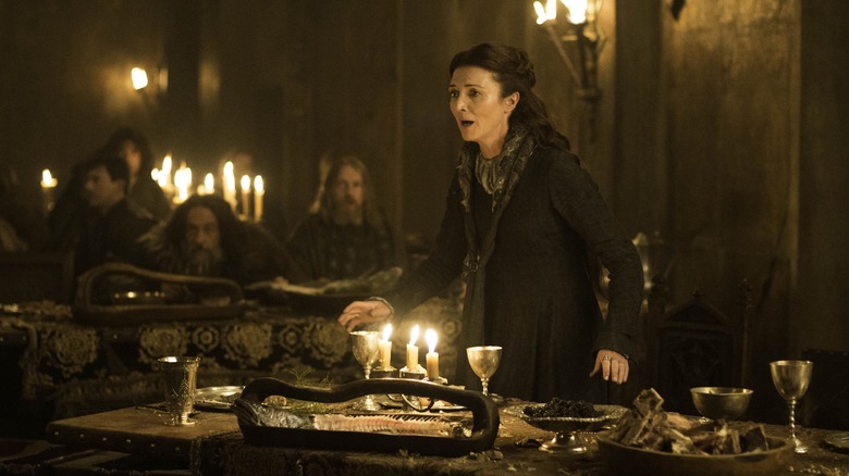 Catelyn Stark stands in a shock at the red wedding at Game of Thrones
