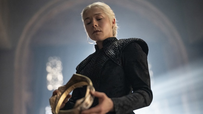 Emma D'Arcy as Queen Rhaenyra Targaryen holding a crown in House of the Dragon season 3