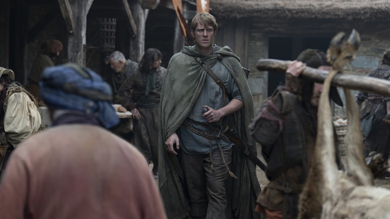 Donk walks through a crowd of the knight from the seven kingdoms