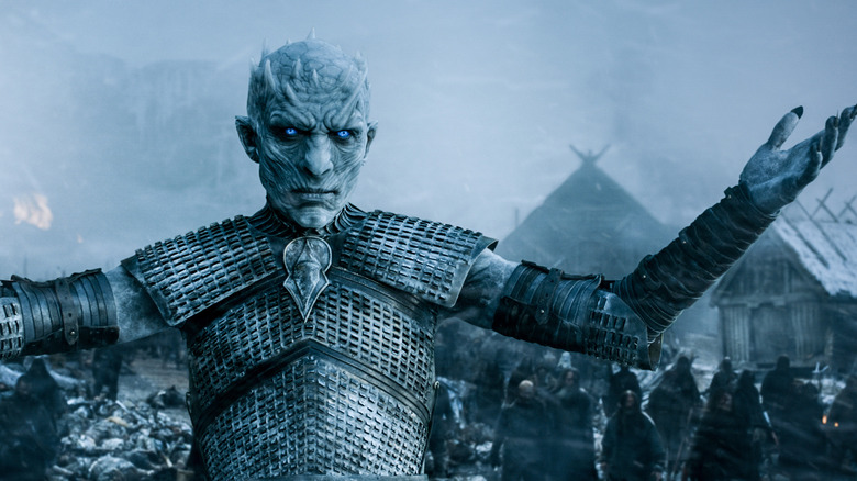 Vladimir Furdik as the Night King raising his arms with an army of the undead behind him in Game of Thrones
