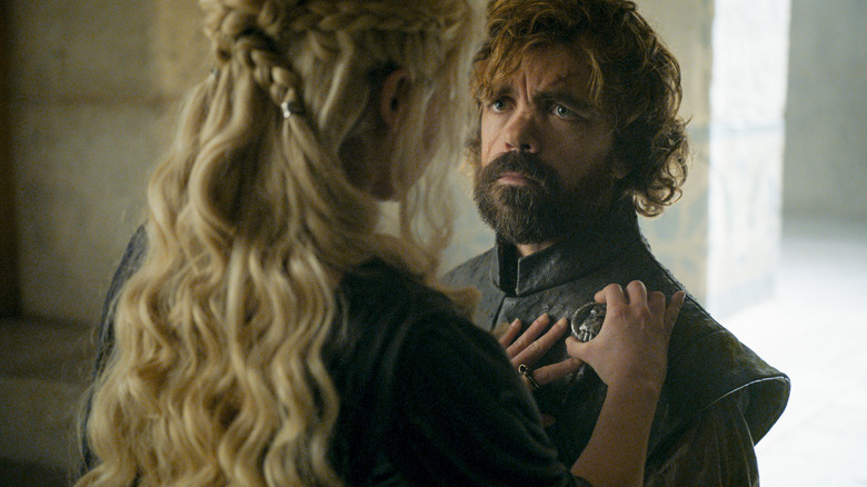 Daenerys pinning the Hand of the Queen pin on Tyrion in Game of Thrones
