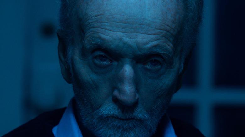 Tobin Bell as John Kramer bathed in blue light in Saw X