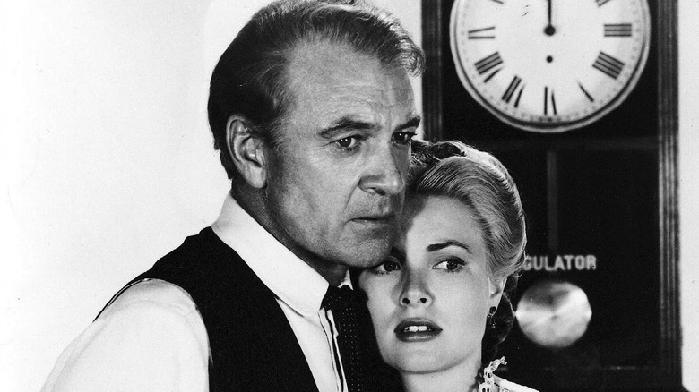 Gary Cooper as Marshal Will Kane and Grace Kelly as Amy Fowler Kane, looking stricken with a clock behind them