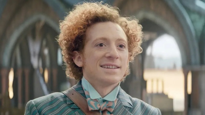 Ethan Slater as Boq Woodsman looking at someone off camera in Wicked