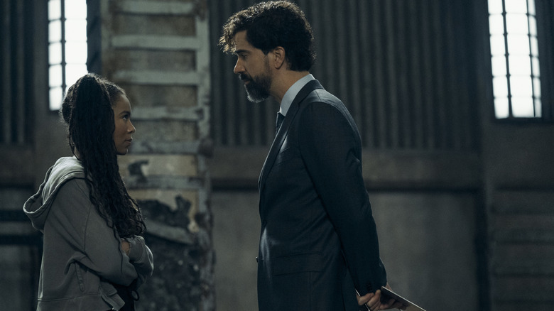 Jaz Sinclair as Marie Moreau folding her arms defensively while Hamish Linklater as Dean Cipher looms over her in Gen V season 2