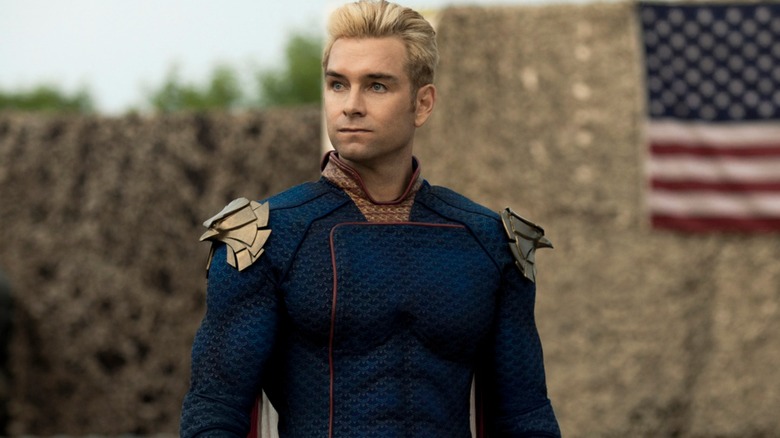 The Boys - Antony Starr as Homelander standing in front of hay with American flag on it