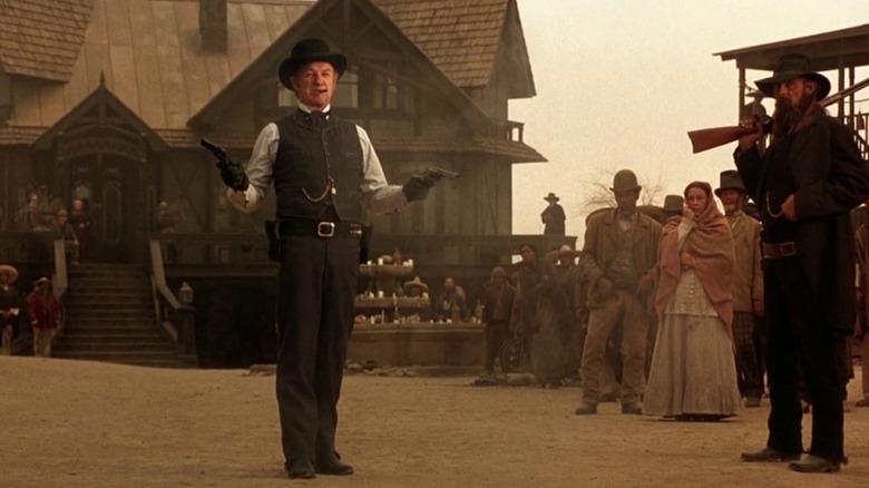 Gene Hackman holds pistols as John Herod in The Quick and the Dead