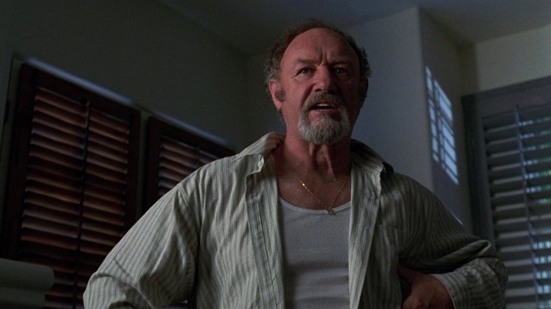 Harry Zimm in a shaded room looking angry in Get Shorty