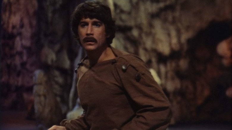 Dylan Hunt (Alex Cord) runs through a cave in Genesis II