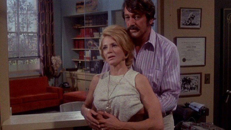Tiger McDrew (Rock Hudson) embraces Betty Smith (Angie Dickinson) from behind in Pretty Maids All in a Row
