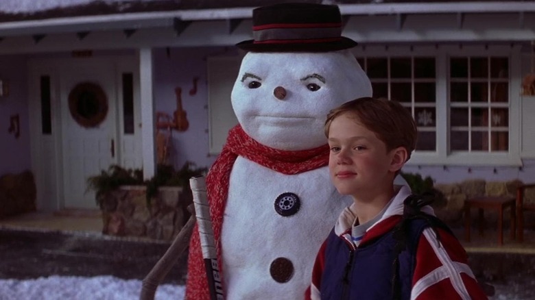 Jack Frost puppet and Joseph Cross as Charlie Frost standing on the front lawn in Jack Frost