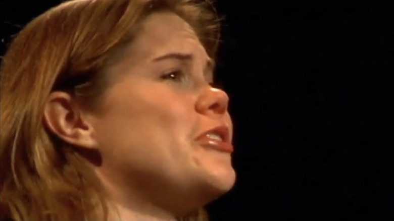 Jennifer Hall looks upset against a black background in Unscripted
