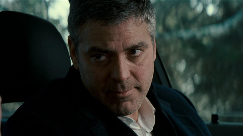 George Clooney in the role of Michael looks at his son in his car in Michael Clayton