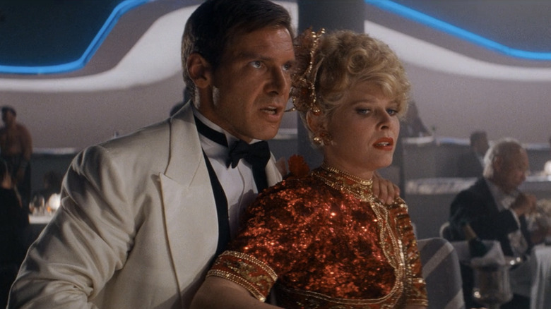 Harison Ford's Indiana Jones stands alongside Kate Capshaw's Willie Scott in Indiana Jones and the Temple of Doom