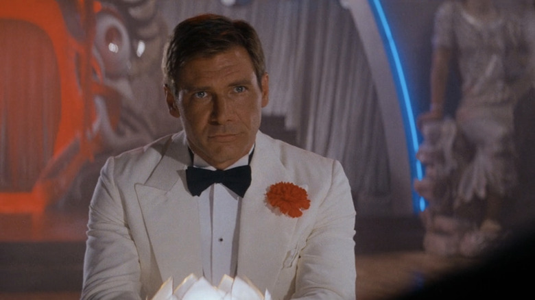 Harison Ford's Indiana Jones stands in a tuxedo in a nightclub in Indiana Jones and the Temple of Doom