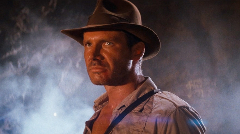 Harison Ford's Indiana Jones stands in a cave in Indiana Jones and the Temple of Doom