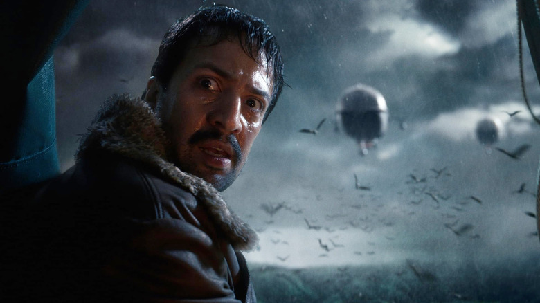 Lin-Manuel Miranda as Lee Scorseby looking panicked during a storm in His Dark Materials