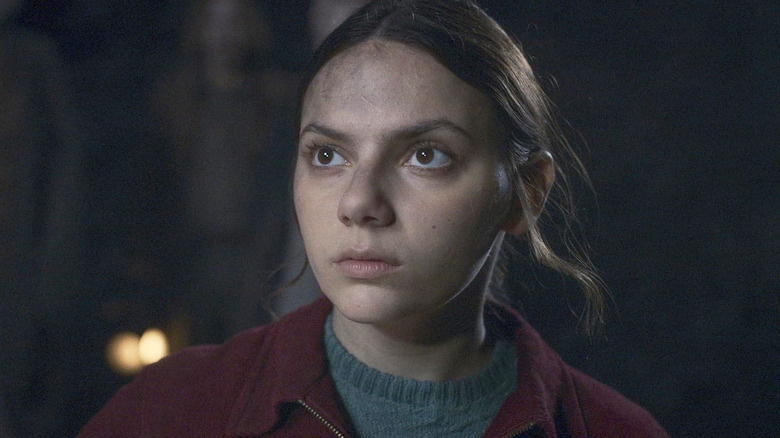 Dafne Keen as Lyra looking up at something in His Dark Materials