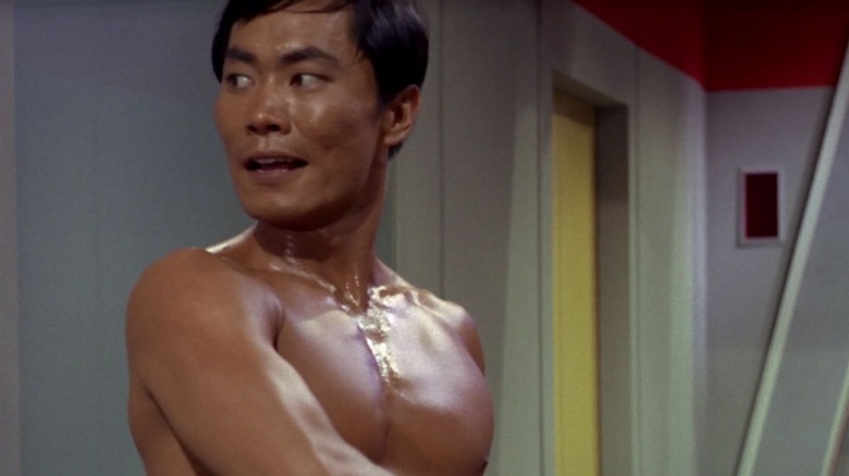 Sulu shortless with a sword in Star Trek
